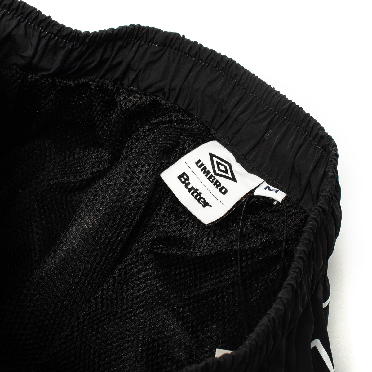 Butter Goods - Long Track Shorts x Umbro
Color : Black