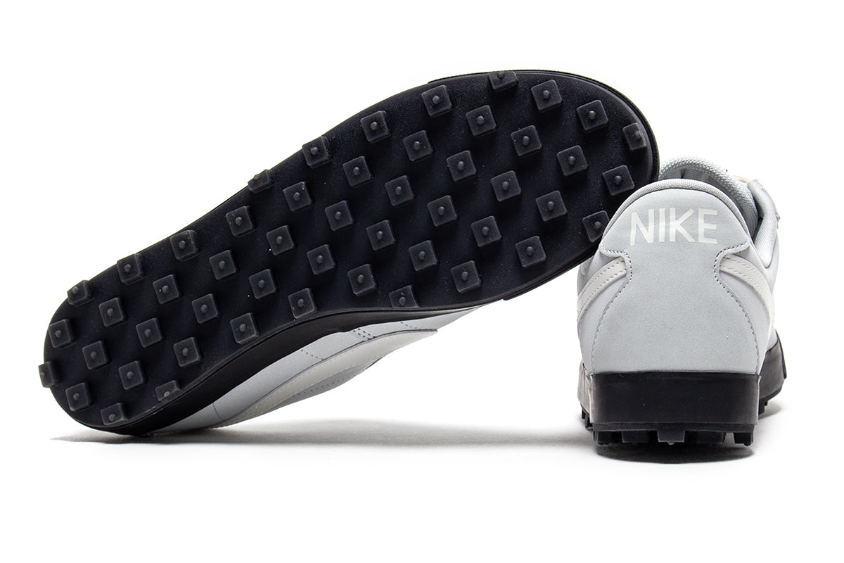 Nike - Astrograbber
Style # IH2341-001
Color : Light Silver / Sail / Phantom / Black
Materials : Leather Upper - Rubber Outsole
Sizing : US Men's