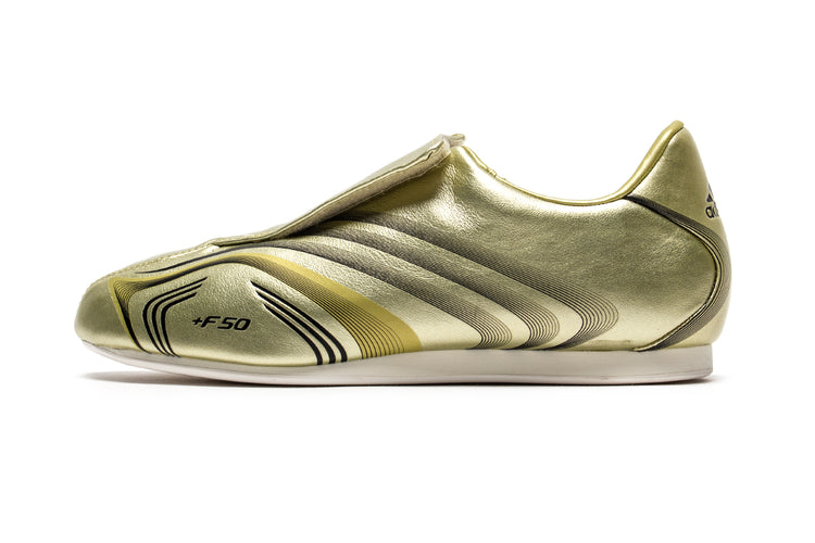 Adidas - Women's Taekwondo F50
Style # IH1872
Color : Gold Metallic / Core Black / Off White
Materials : Leather Upper - Rubber Outsole
Sizing : US Women's