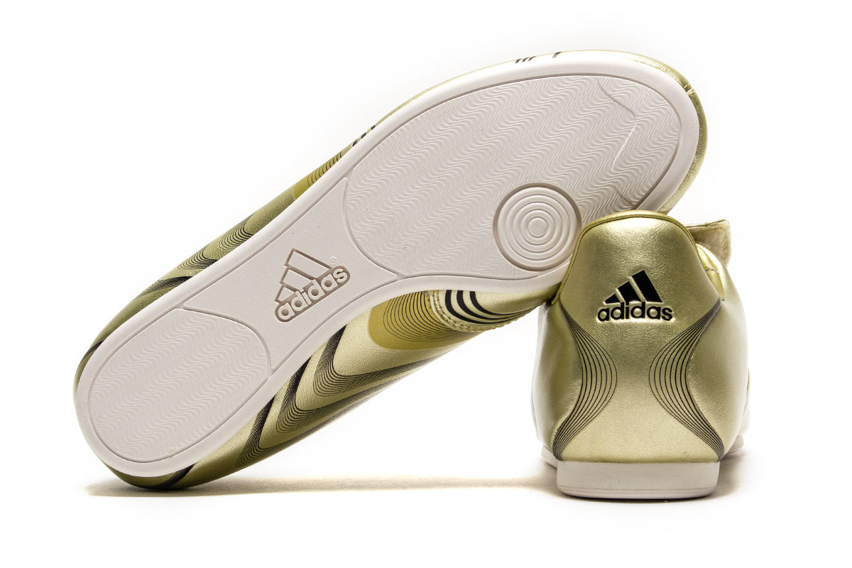 Adidas - Women's Taekwondo F50
Style # IH1872
Color : Gold Metallic / Core Black / Off White
Materials : Leather Upper - Rubber Outsole
Sizing : US Women's