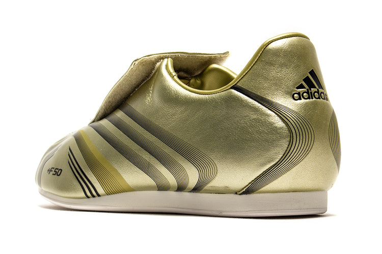 Adidas - Women's Taekwondo F50
Style # IH1872
Color : Gold Metallic / Core Black / Off White
Materials : Leather Upper - Rubber Outsole
Sizing : US Women's