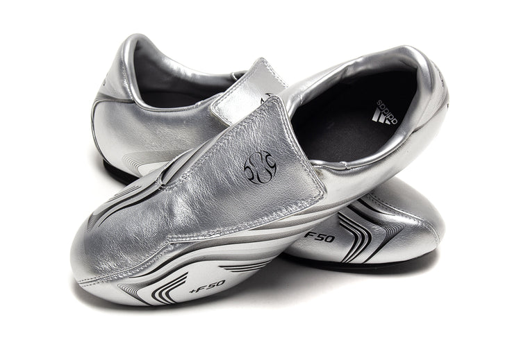 Adidas - Women's Taekwondo F50
Style # IH1873
Color : Silver Metallic / Core Black
Materials : Leather Upper - Rubber Outsole
Sizing : US Women's