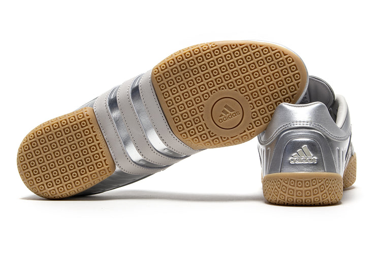 Adidas - Women's Taekwondo Mei Elite
Style # IH9387
Color : Silver Metallic / Grey One / Gum
Materials : Leather Upper - Rubber Outsole
Sizing : US Women's