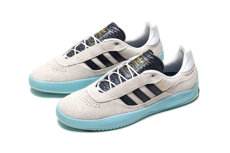 Adidas | Puig
Style # JH8166
Color : Crystal White / Core Black / Light Aqua