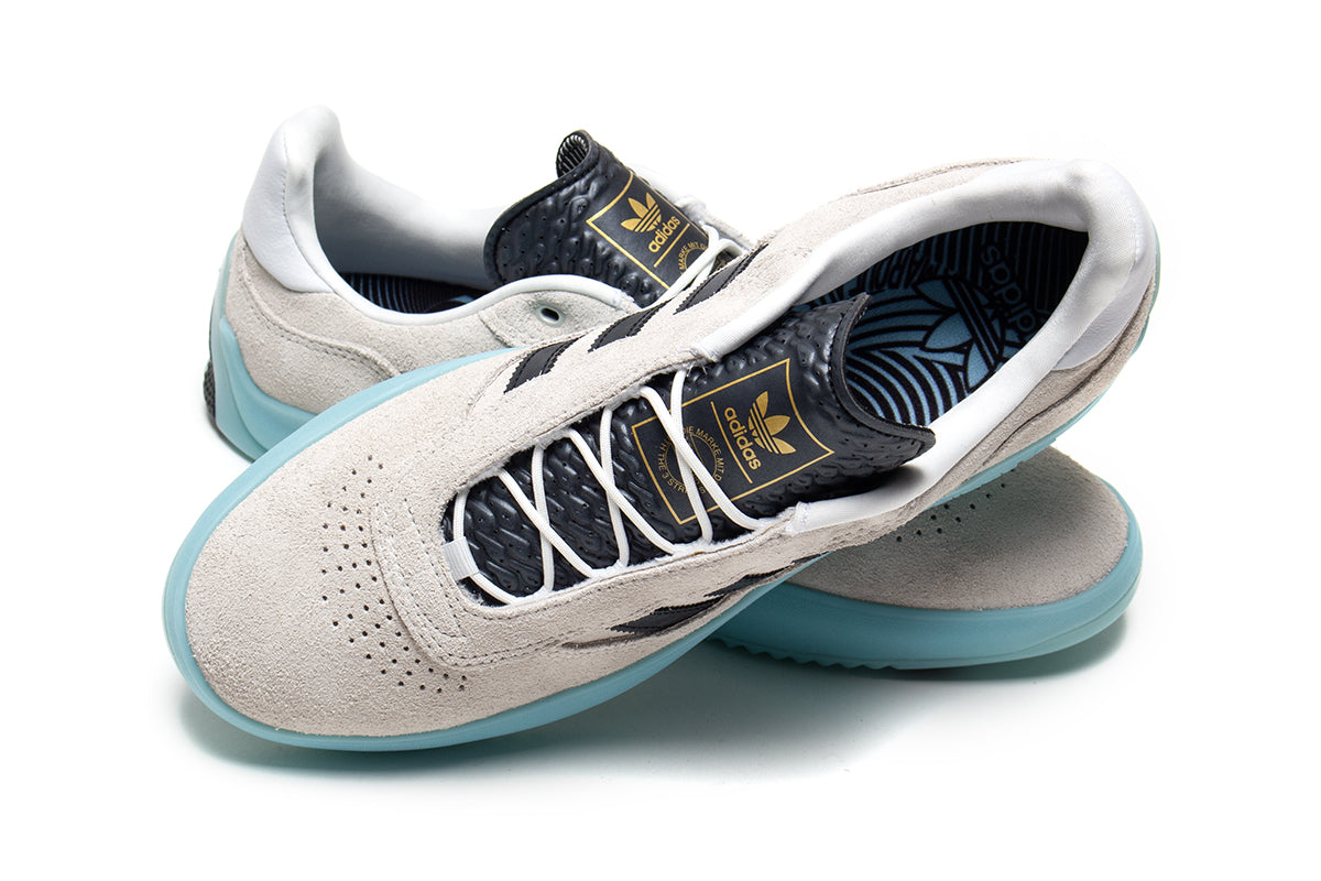 Adidas | Puig
Style # JH8166
Color : Crystal White / Core Black / Light Aqua