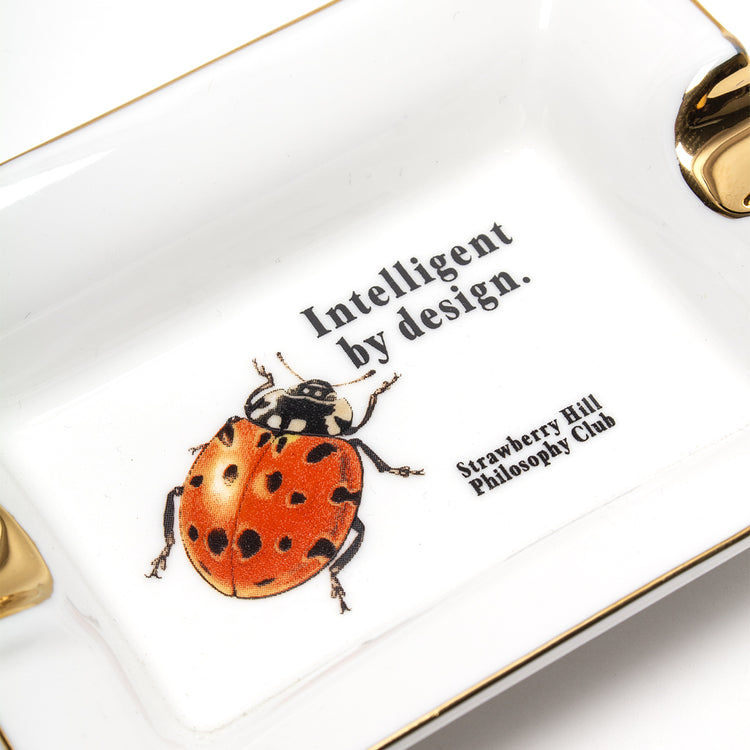 Strawberry Hill Philosophy Club - Intelligent By Design Ceramic Ashtray
Color : White / Gold