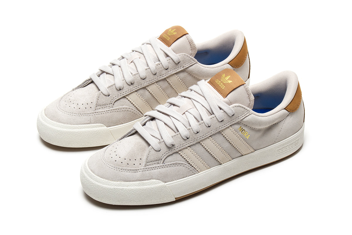 Adidas - Nora
Style # JP8594
Color : Aluminum / Core White / Gold Metallic