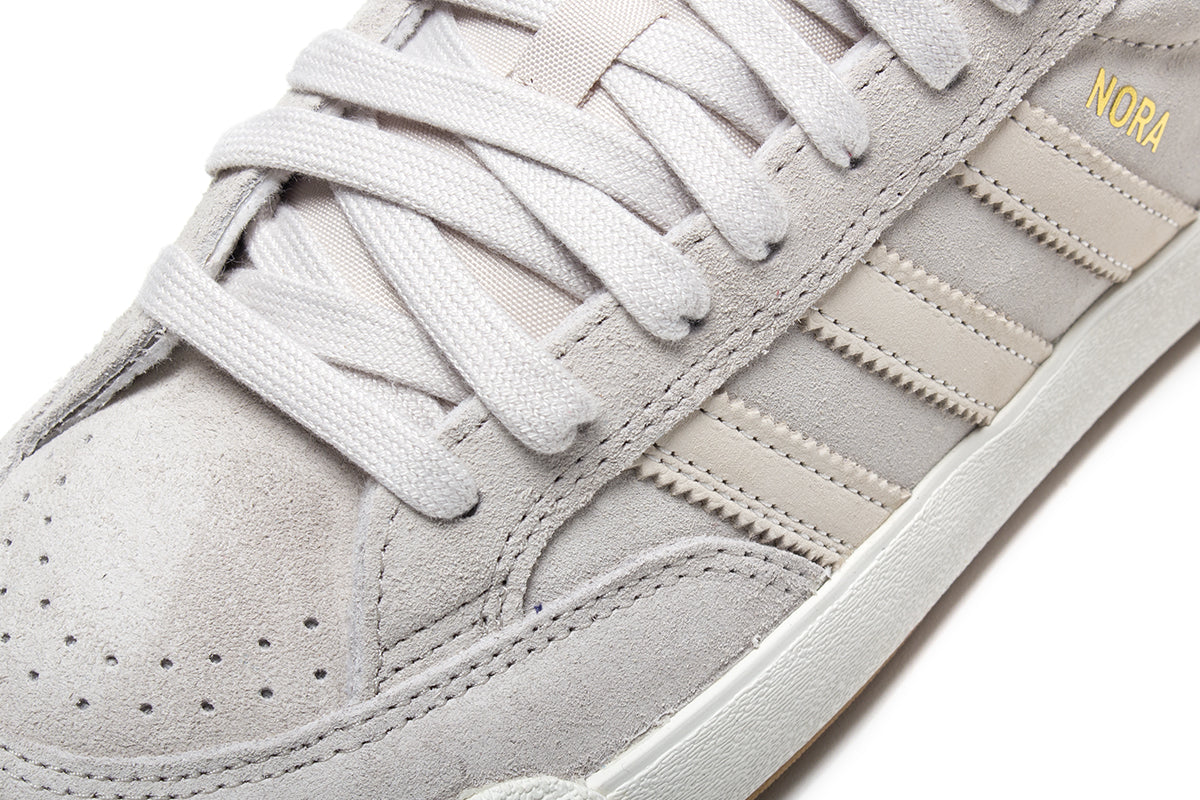 Adidas - Nora
Style # JP8594
Color : Aluminum / Core White / Gold Metallic