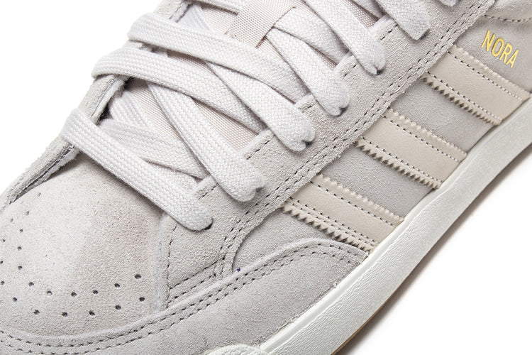 Adidas - Nora
Style # JP8594
Color : Aluminum / Core White / Gold Metallic