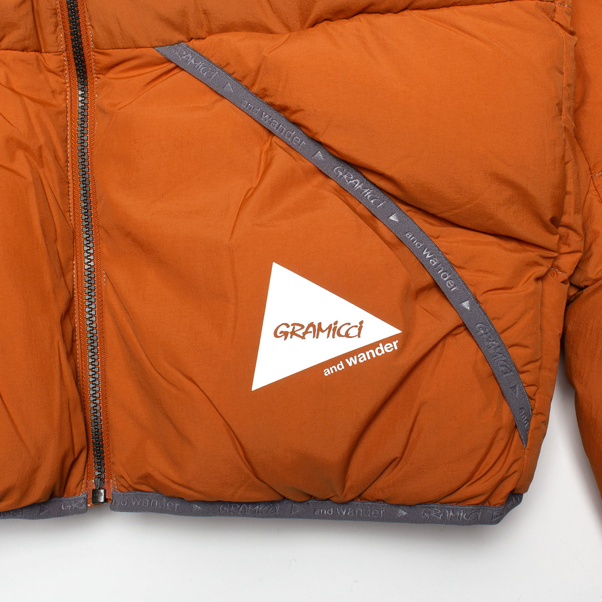 Gramicci x And Wander | Down Jacket
Color : Orange